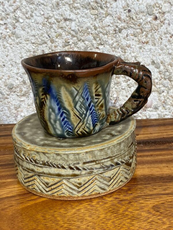 Small hand made porcelain mug with Polynesian tattoo designs and the unique Huahine blue and yellow glazes. All of our mugs become a very personal part of your daily coffee or tea ritual.