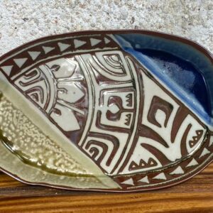 Medium size porcelain oval platter with brown carved Polynesian designes surrounded with beautiful Huahine blue and green glazes. This piece has a very local feeling.